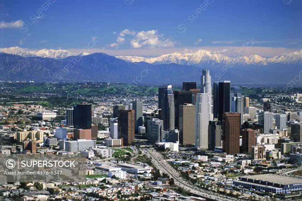 Aerial view of downtown Los Angeles with snow on San Gabriel Mountains