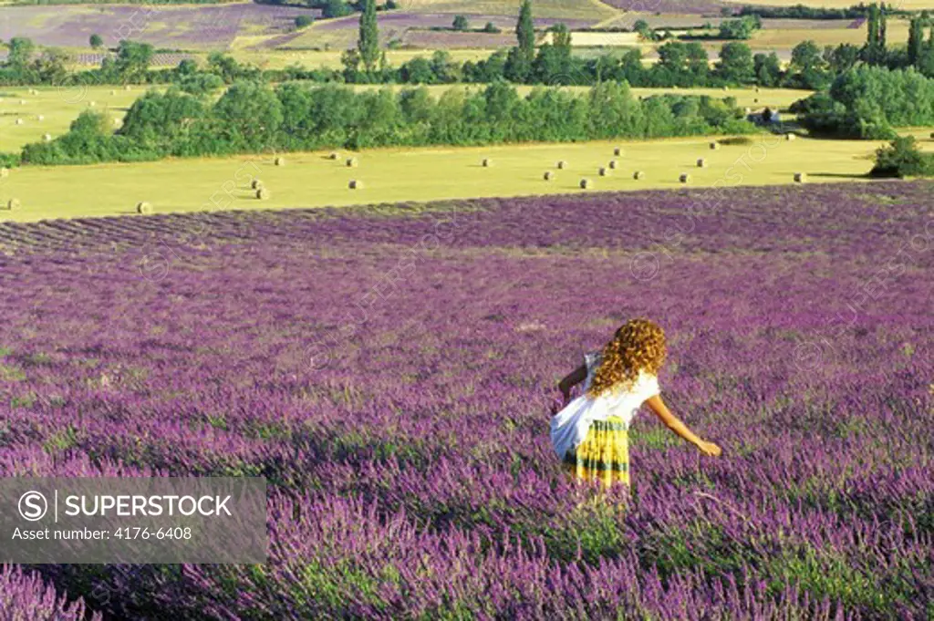 Woman in local dress in field of lavender in Provence