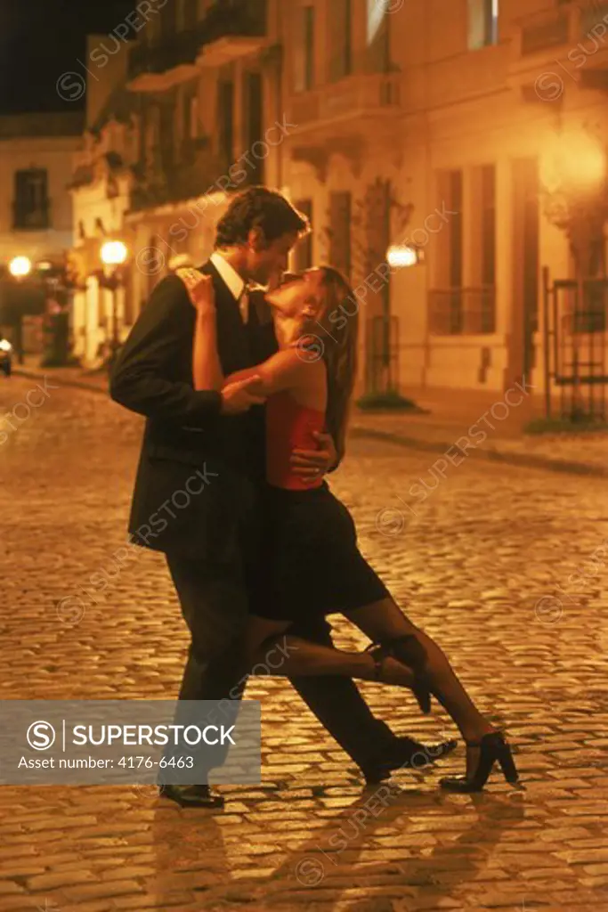 Couple tango dancing on the streets of San Telmo at night in Buenos Aires