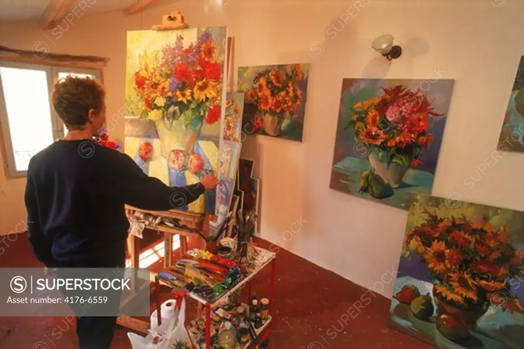 Artist painting in studio in Provence