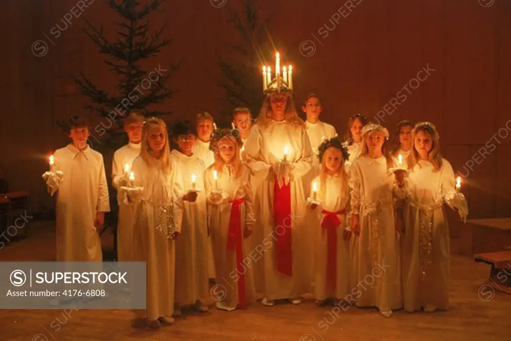 Choir of children with candles on Saint Lucia Day in Sweden