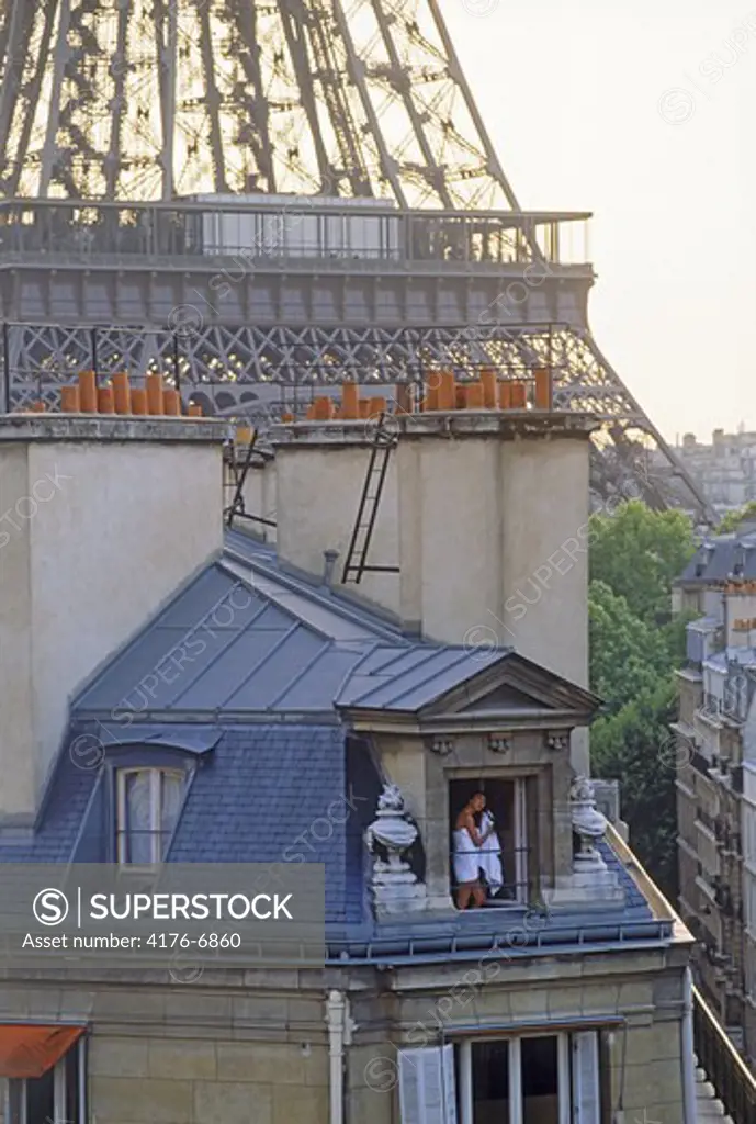 Women in Paris apartment drying hair after shower