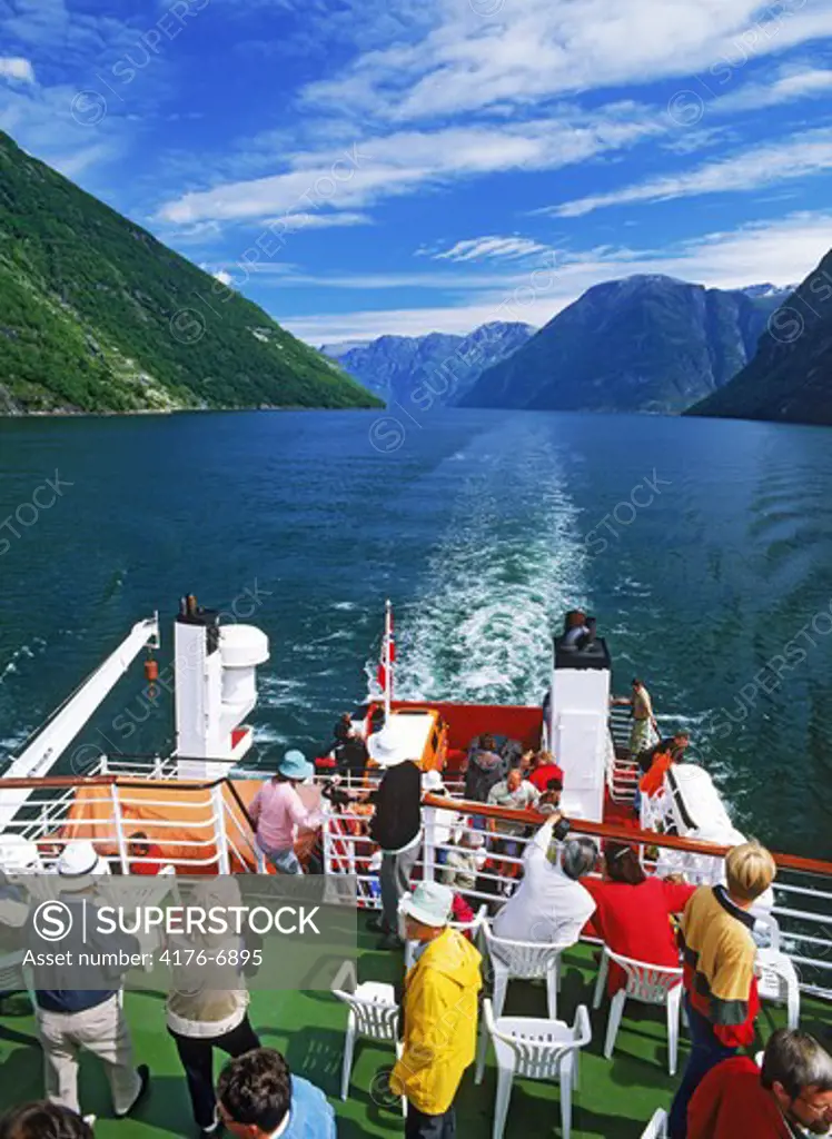 Passengers on deck of car ferry on Geirangerfjord in Norway