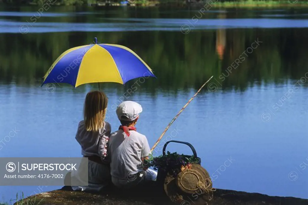 Boy and girl on fishing picnic in Sweden