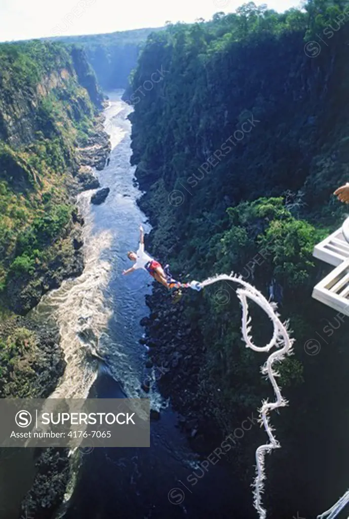 Bungee jumping off 152 meter high Victoria Falls Bridge above Zambezi River between Zimbabwe and Zambia