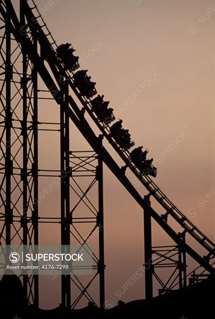 Silhouette of a rollercoaster in an amusement park, Tivoli Gardens, Copenhagen, Denmark