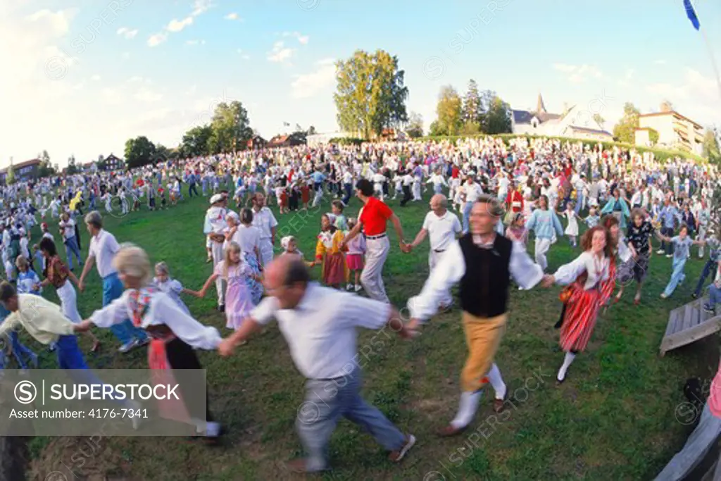 People dancing around Maypole during Midsummer Celebrations at Leksand in Dalarna Sweden