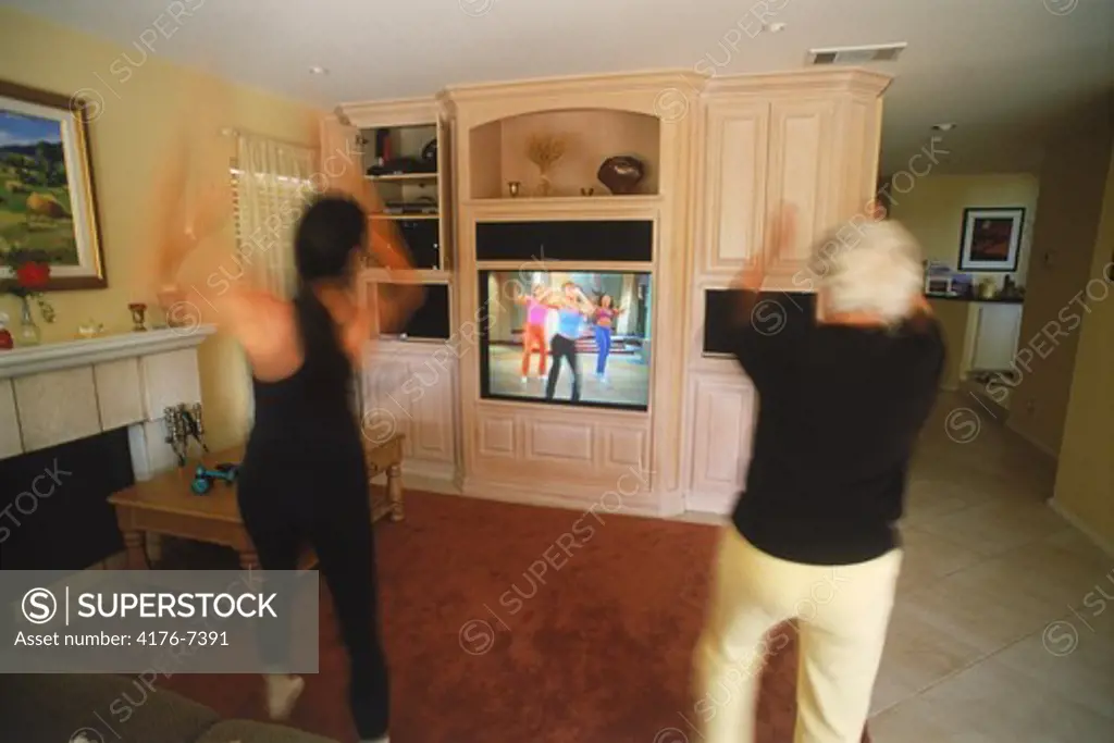 Mother and Grandmother exercising to home video