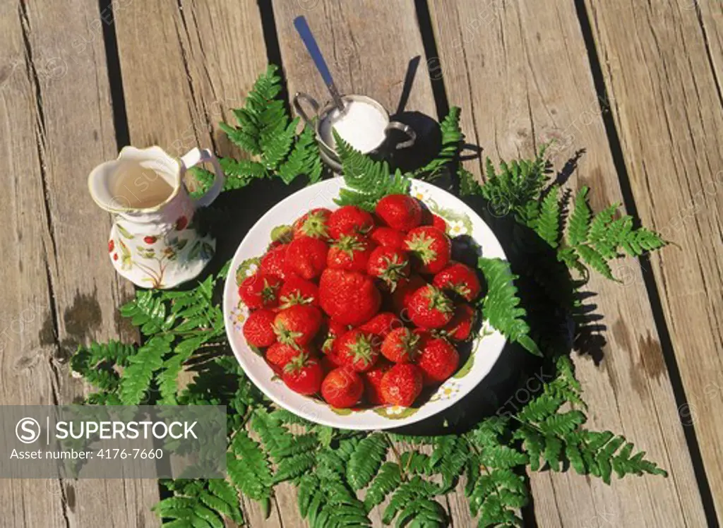 Bowl of strawberries with creram and sugar