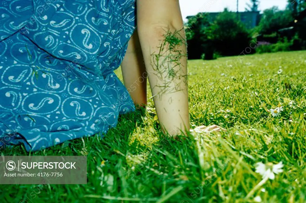 Grass stuck to a person's elbow