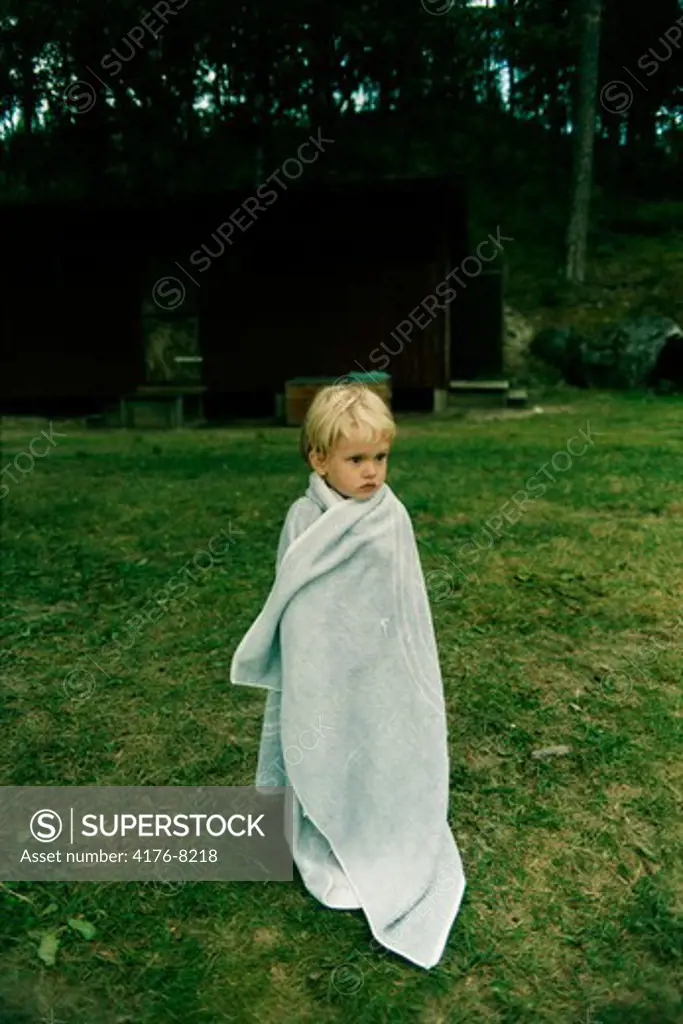 A boy wrapped in a towel