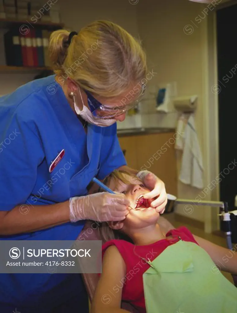 A dentist examing a child