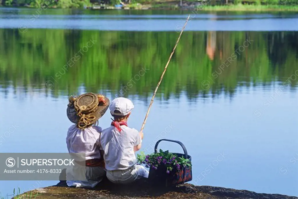 Two children on summertime fishing picnic