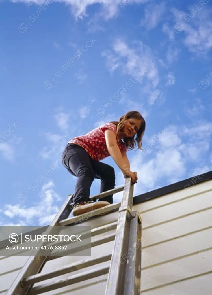 A girl climbing up a ladder