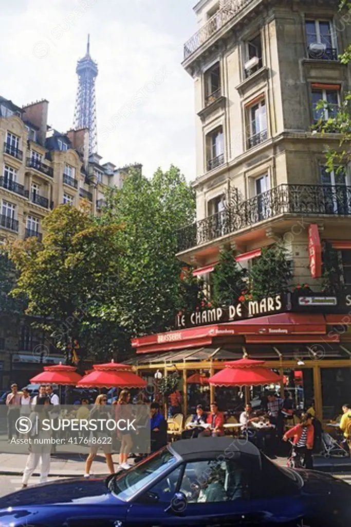 Street life and sidewalk cafe near Eiffel Tower in Paris