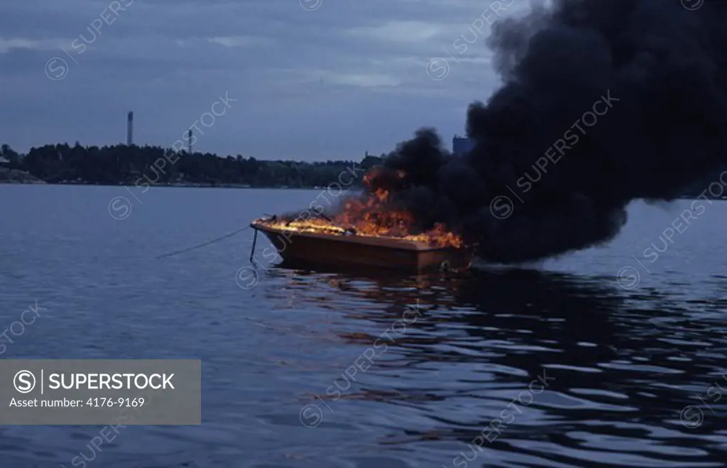 Smoke rising from the fire in a burning boat