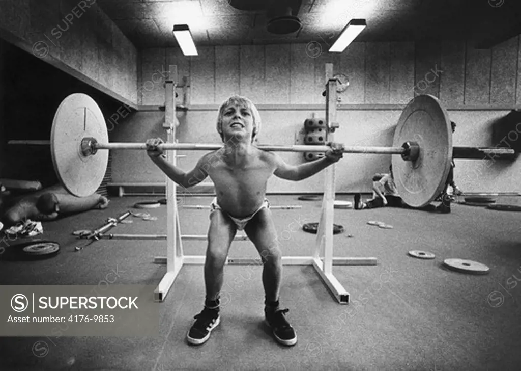 Front view of a boy lifting weight