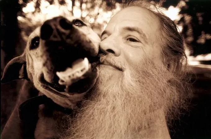 A long-white beard trainer with a dog