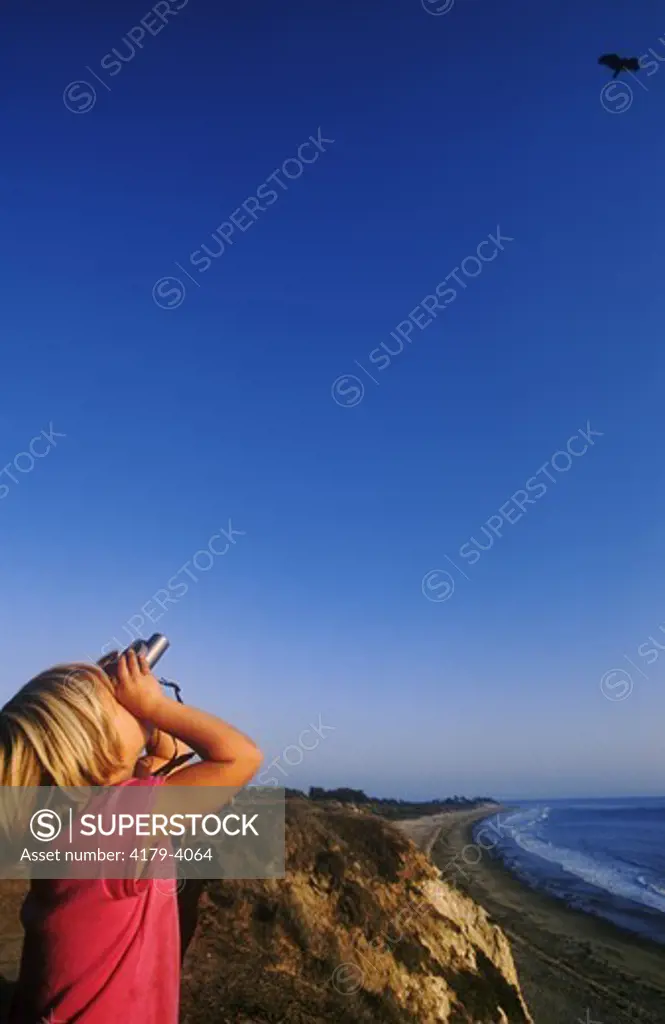 Girl birdwatching at Ellwood Bluffs, Gaviota Coast, Goleta, CA