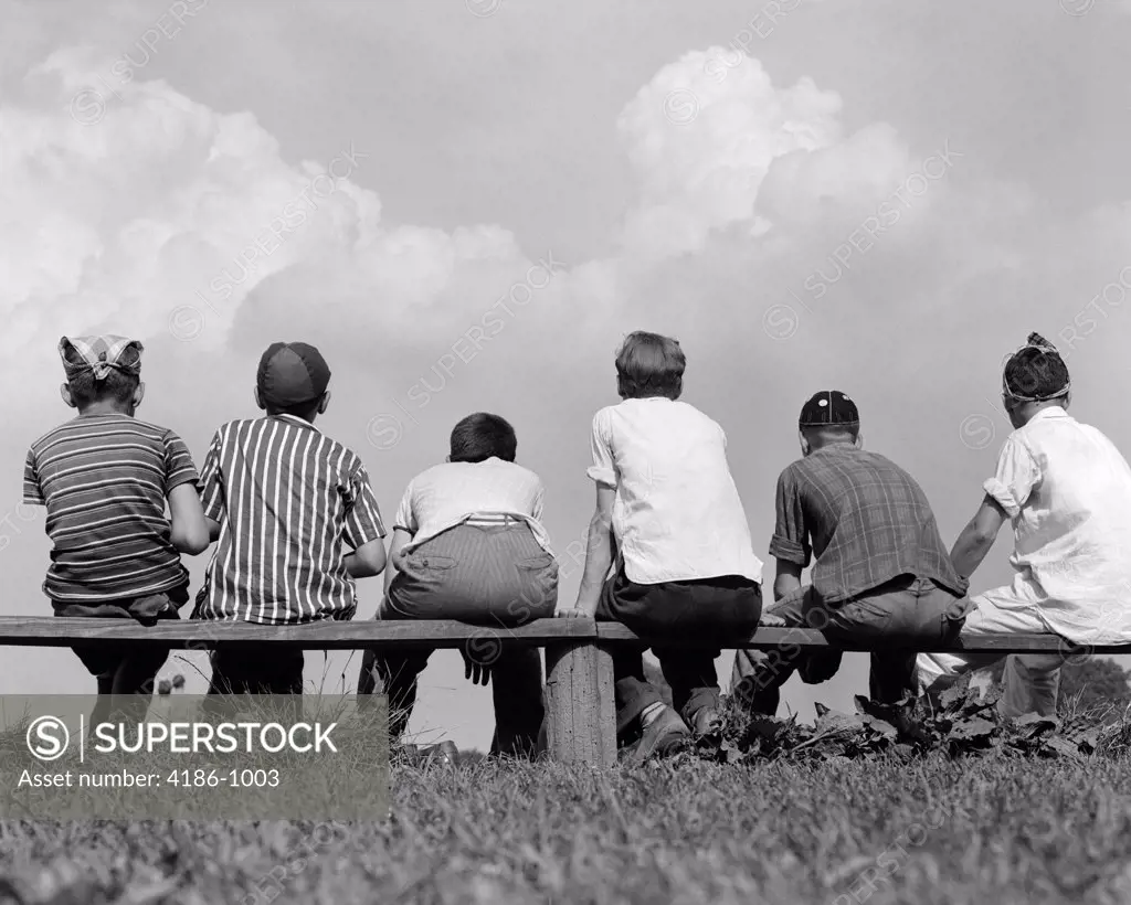 1960S Back View Of Six Boy Baseball Players Sitting On Bench