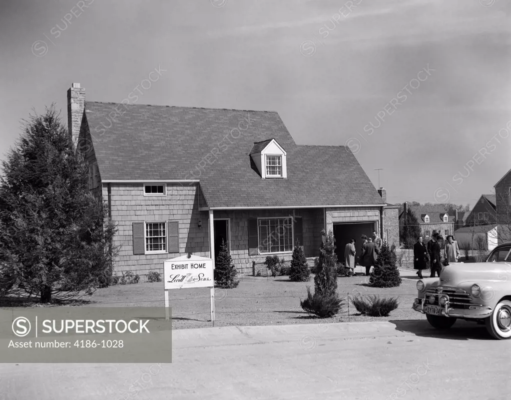 1950S Model Home With Sign Of Levitt & Sons Exhibit Home & People Milling About