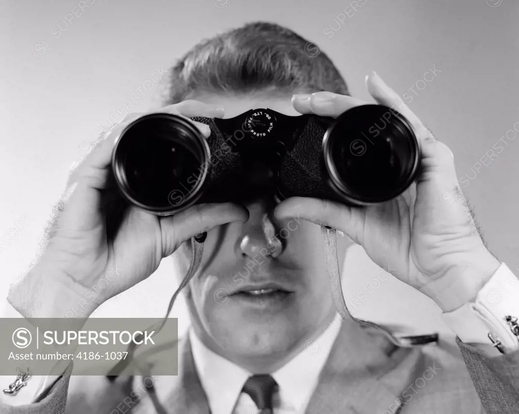 1960S Head-On Close-Up Of Man Looking Through Binoculars
