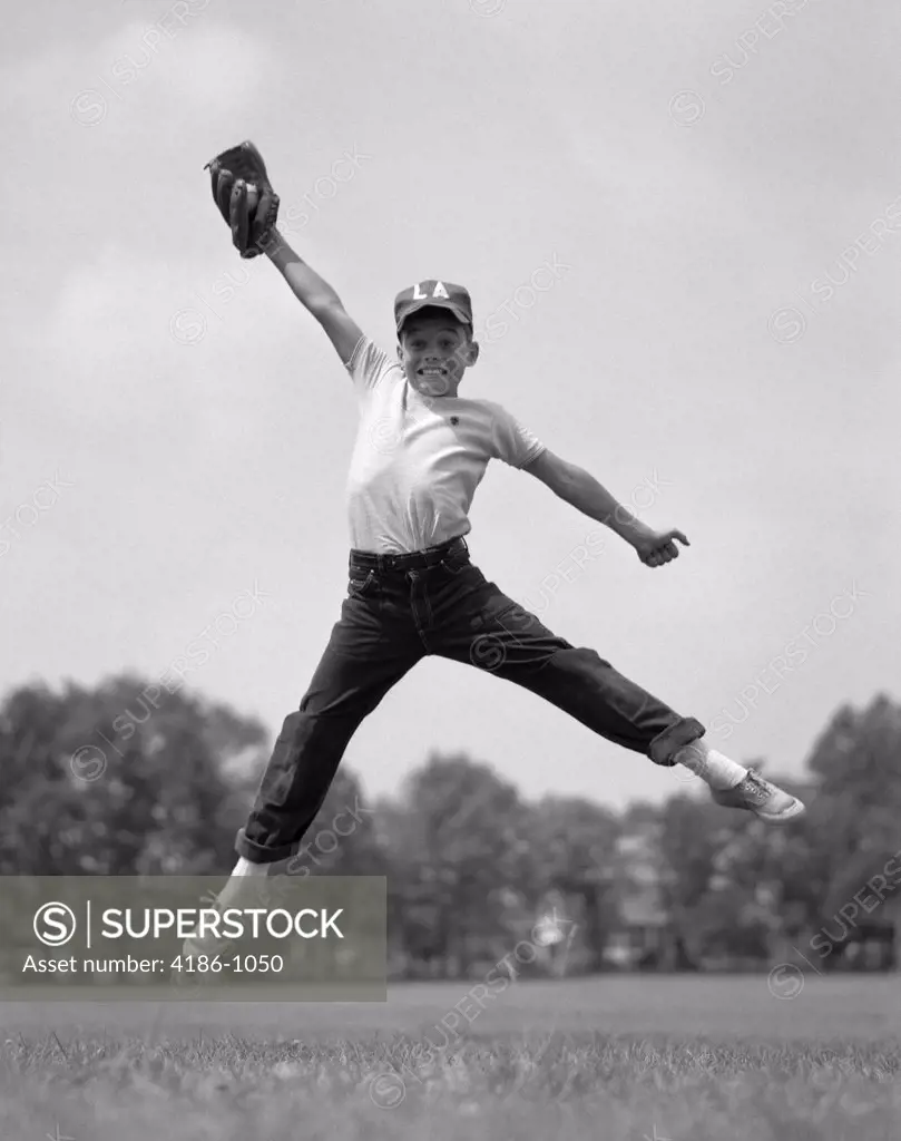 1960S Boy Jumping In Outfield To Catch Baseball With Gove