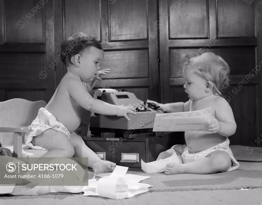 1960S Two Babies Wearing Diapers In Business Office With Adding Machine Playing Accountant