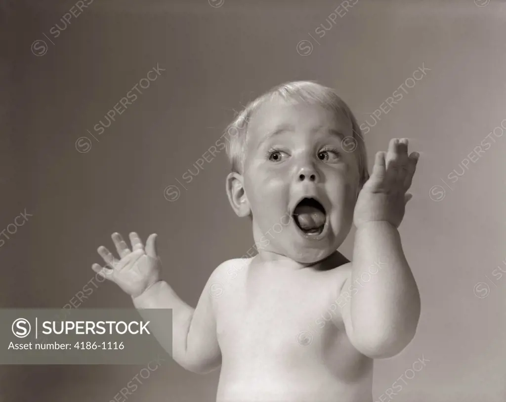 1960S Portrait Baby With Hands In Air And Eyes & Mouth Wide Open