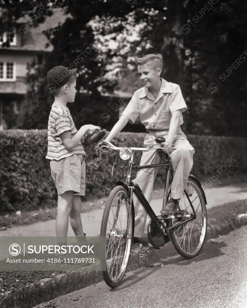 1940s TWO BOYS MEETING TALKING OLDER ONE PRETEEN SITTING ON ENGLISH STYLE BICYCLE OTHER YOUNGER HOLDING BASEBALL AND MITT
