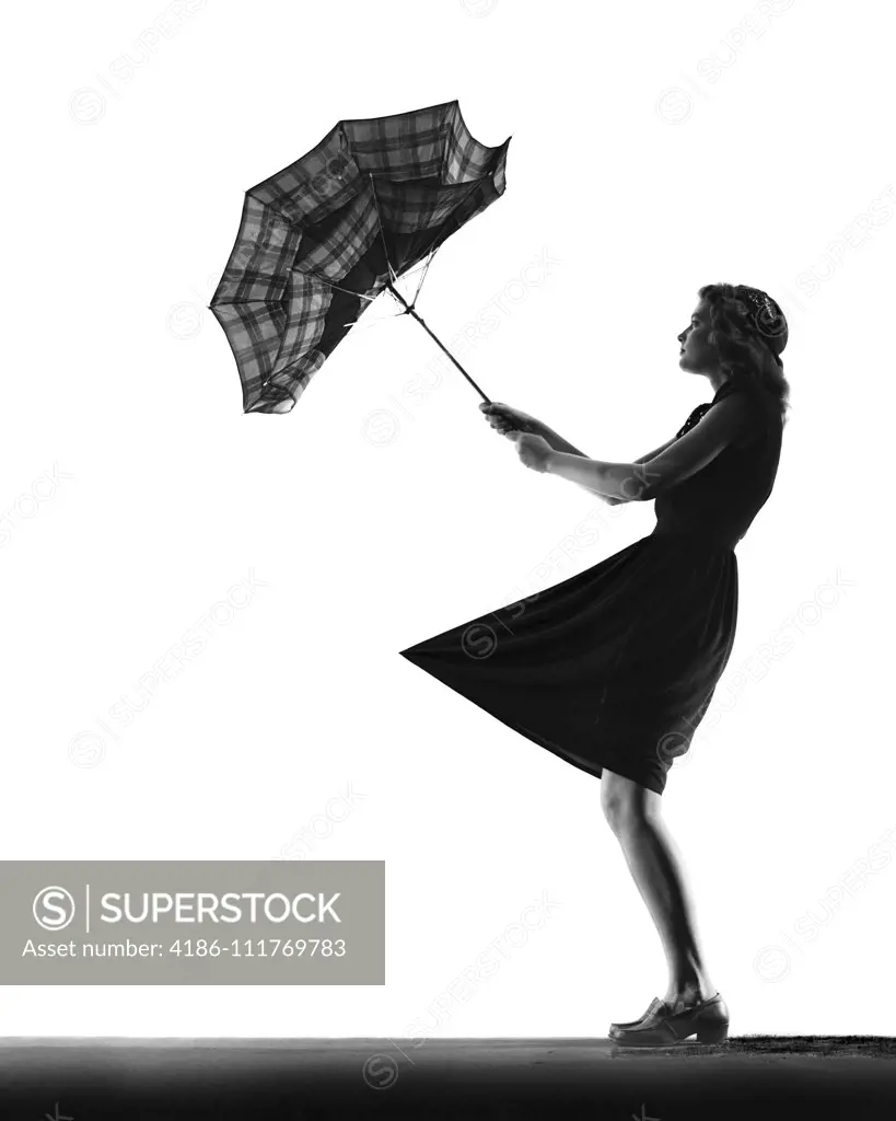 1930s 1940s ANONYMOUS SILHOUETTE OF TEENAGE  GIRL WITH UMBRELLA TURNED INSIDE OUT IN THE WIND