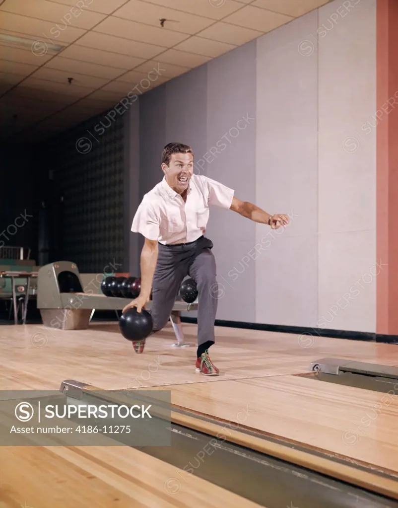 1960S Man Bowling Indoor About To Release Ball In Alley