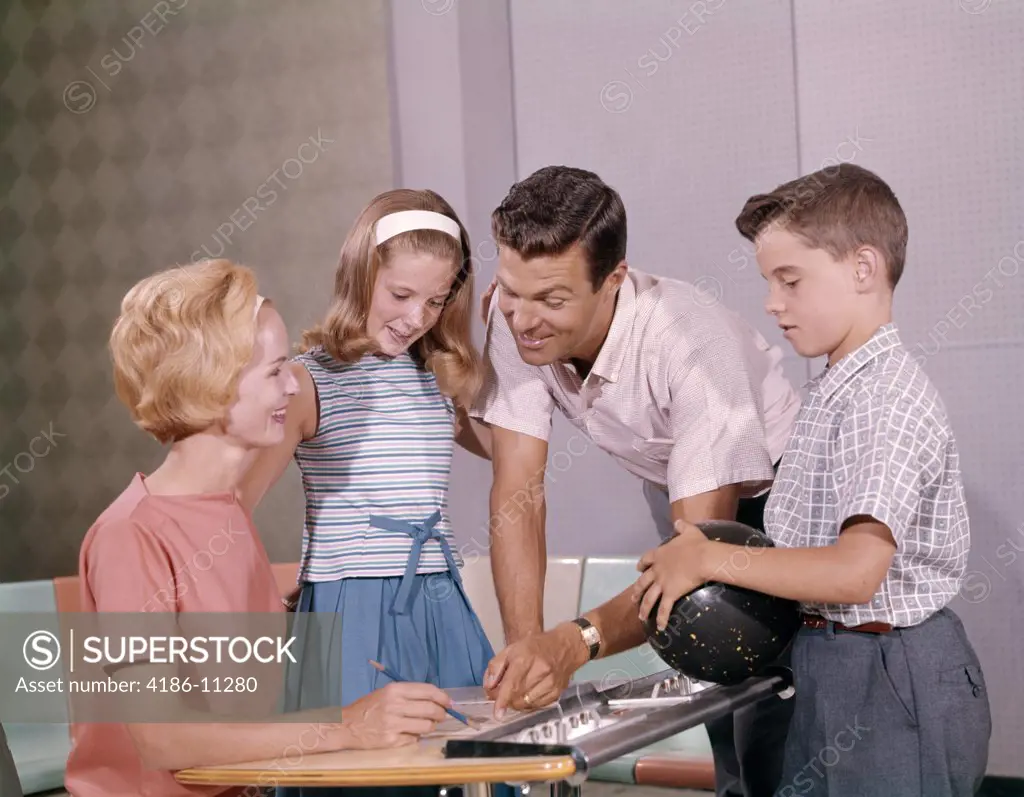1960S Family Mother Father Daughter Son Together Bowling Looking At Score 