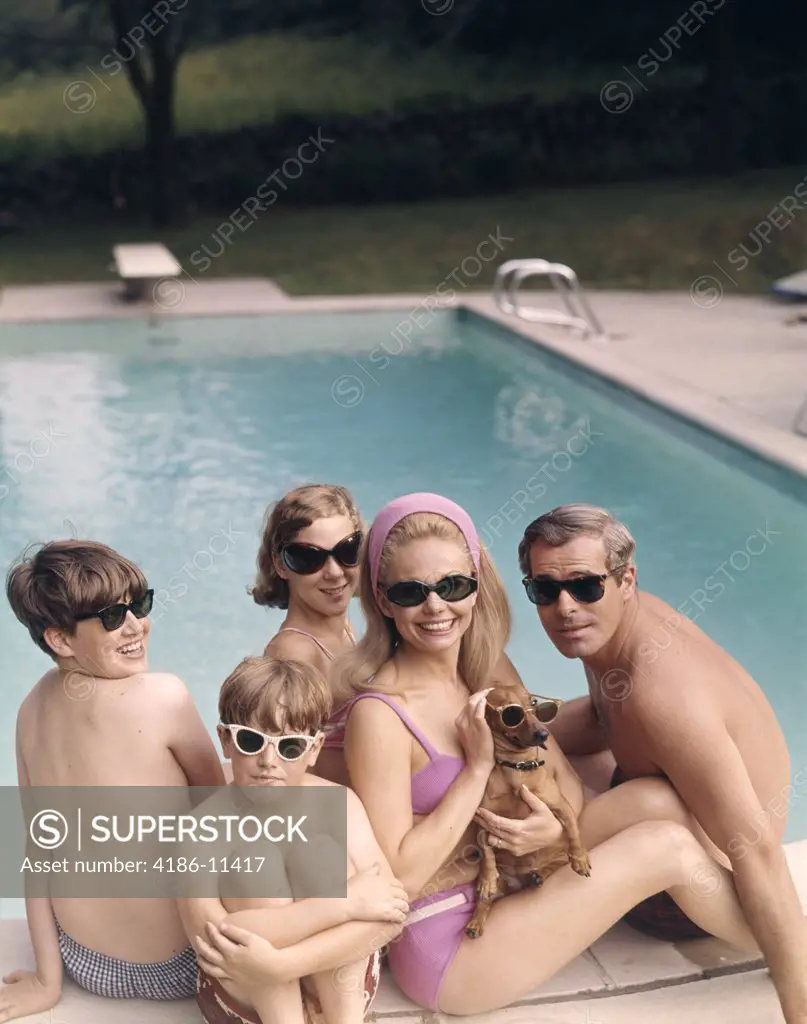 1960S 1970S Family All Wearing Sunglasses Beside Swimming Pool
