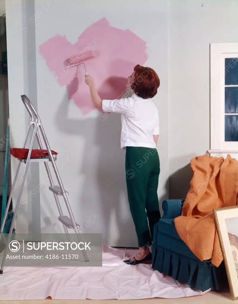 1960S 1970S Woman Painting Wall With Paint Roller Indoor 