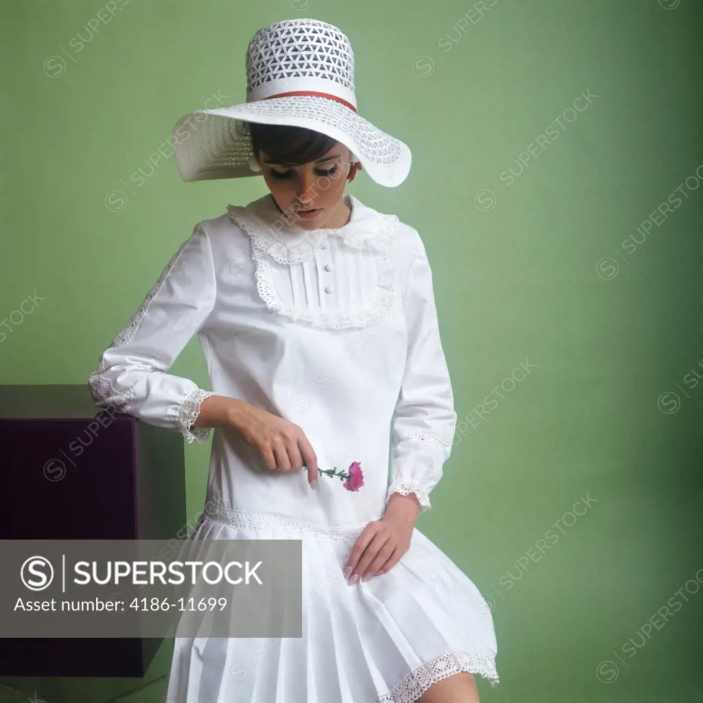 1960S Young Woman White Floppy Straw Hat White Dress Ruffles Pleated Skirt Head Lowered Holding Pink Flower Bride