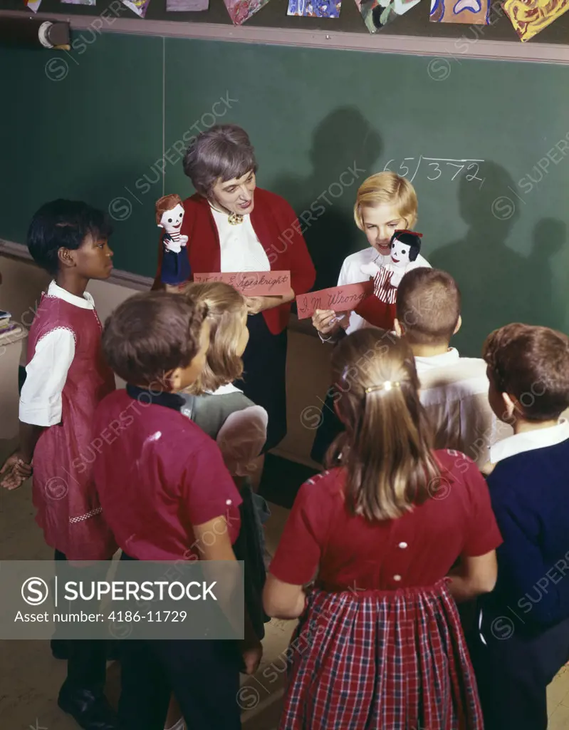 1970S Teacher And Student Showing Hand Puppets To Classmates Gathered Around Them