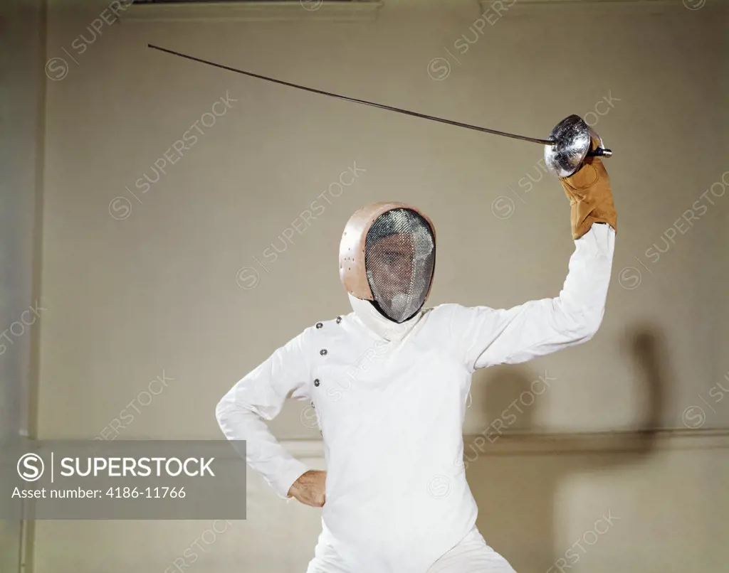 1960S Man Protective Clothing Helmet Wire Face Mask Holding Waving Foil Epee Sword Above Head On Guard Touché Duel