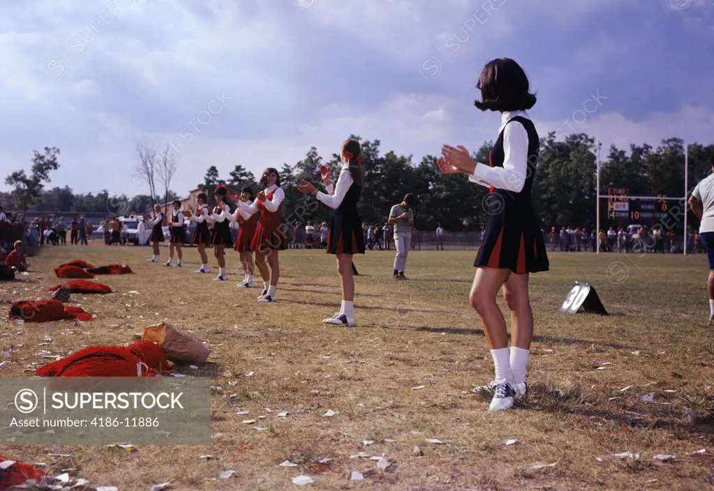 1960S Line Teen Girl Cheerleaders On Sidelines Cheering During High School Football Game Uniform Support Pride