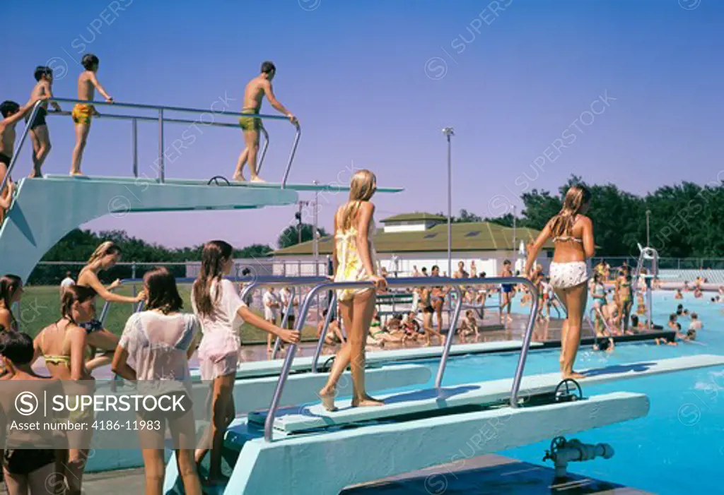 1970S Crowd Of Teens In Pool & On Diving Board At Municipal Swim Pool Mcpherson Kansas Summer Fun Recreation Cool Wet