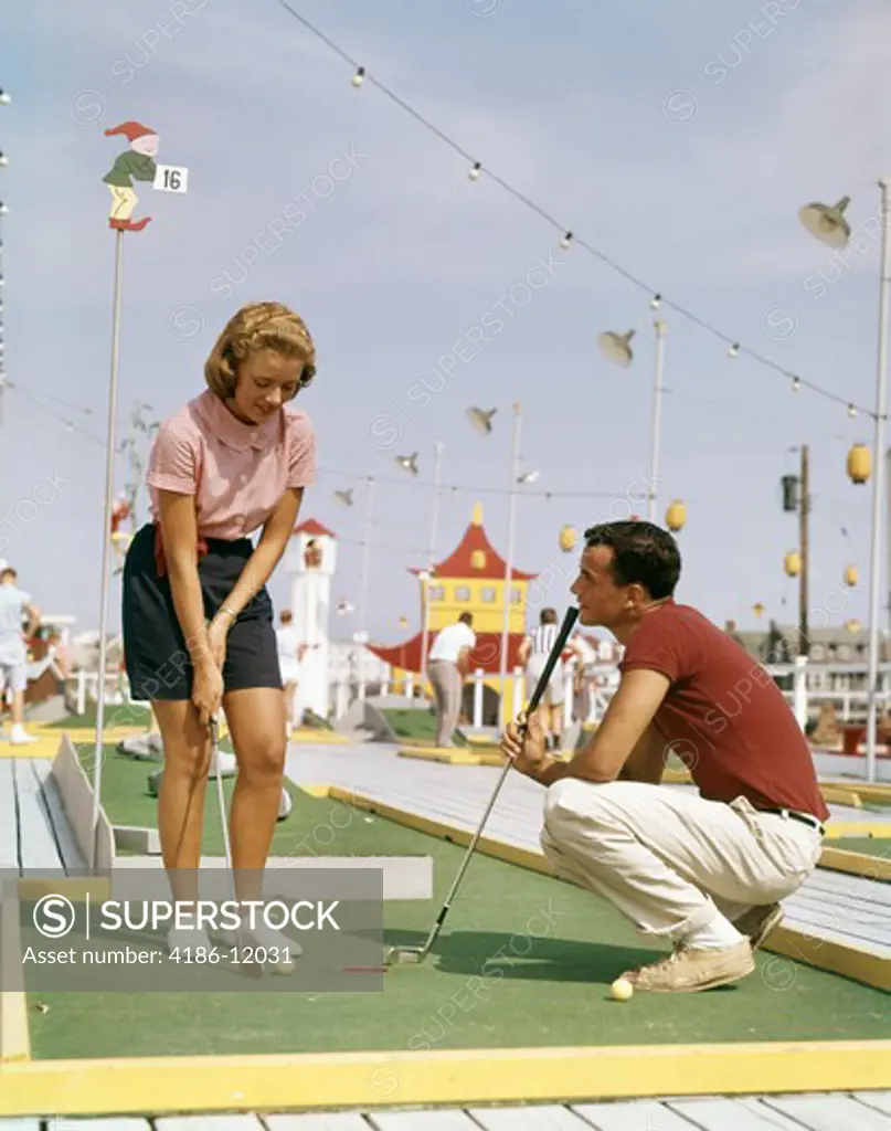 1950S 1960S Young Couple Man Woman Playing Summer Amusement Miniature Golf Game