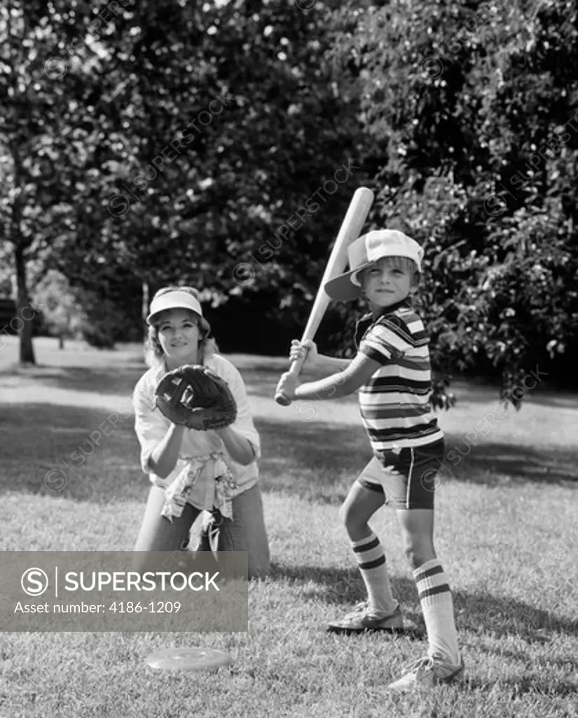 1980S Boy At Bat With Mother Kneeling Behind Him As Catcher