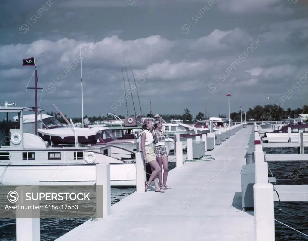 1950S 2 Young Women In Shorts Sandals On Long Marina Pier Fishing Pleasure Boats Bahia Mar Ft. Lauderdale Fl