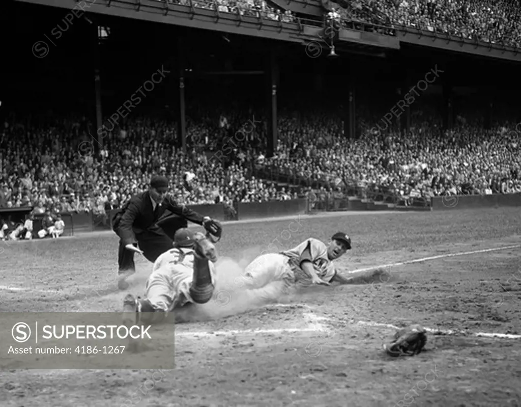 1950S Professional Major League Baseball Game Runner Sliding Into Home Base As Umpire Signals Safe