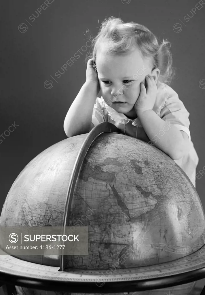 1940S Baby Looking At Leaning On Globe Of Earth