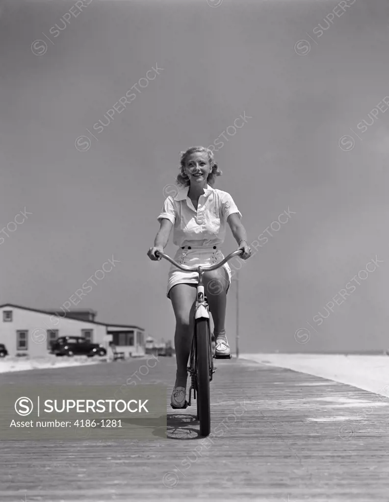 1940S Blond Woman Riding Bike On Beach Boardwalk Summer