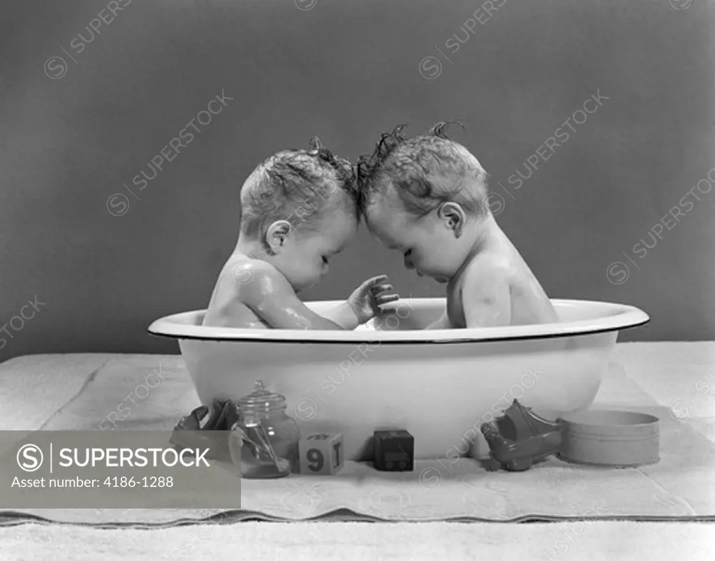 1950S Babies Head To Head In Metal Tub