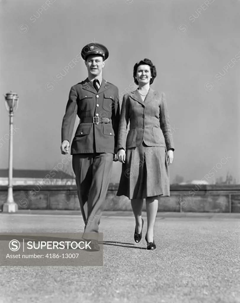 1940S Smiling Couple Walking Forward Man In Army Uniform