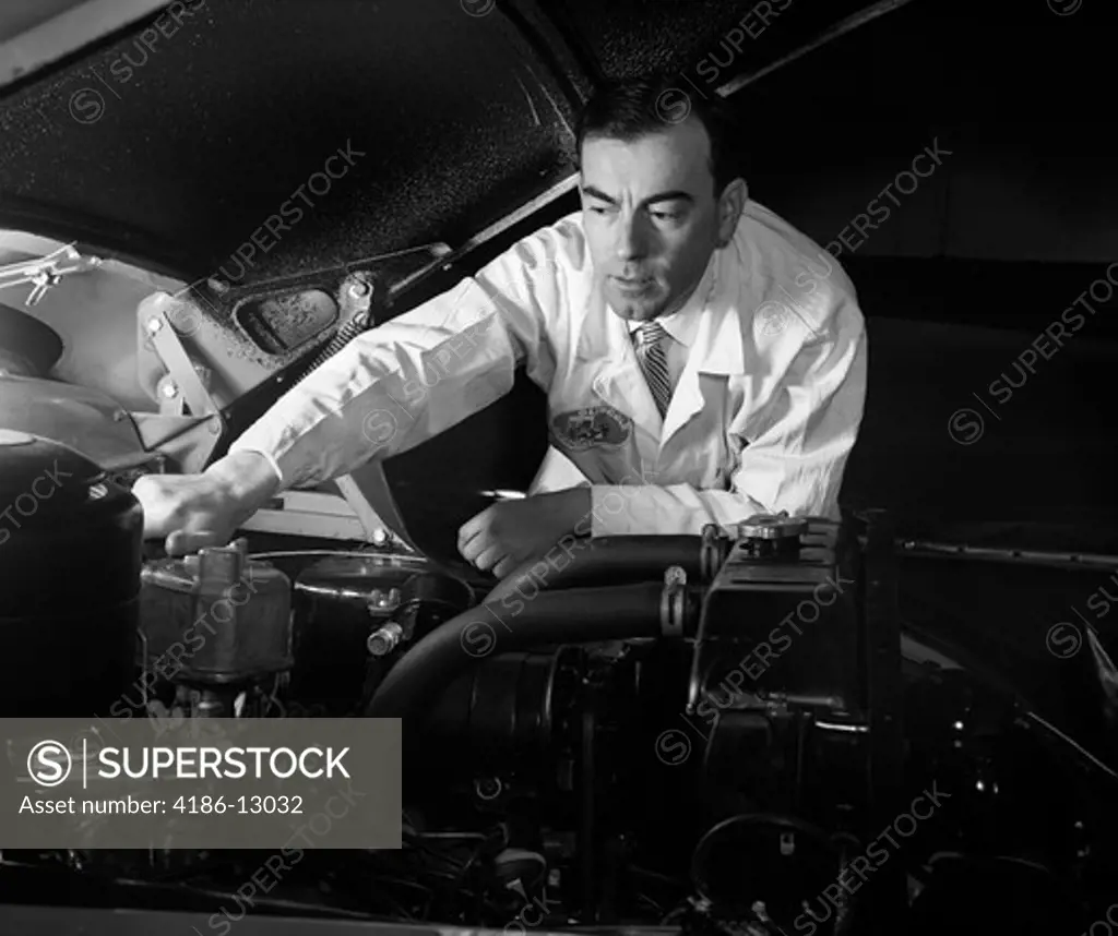 1950S Man Automotive Mechanic Servicing Car Engine
