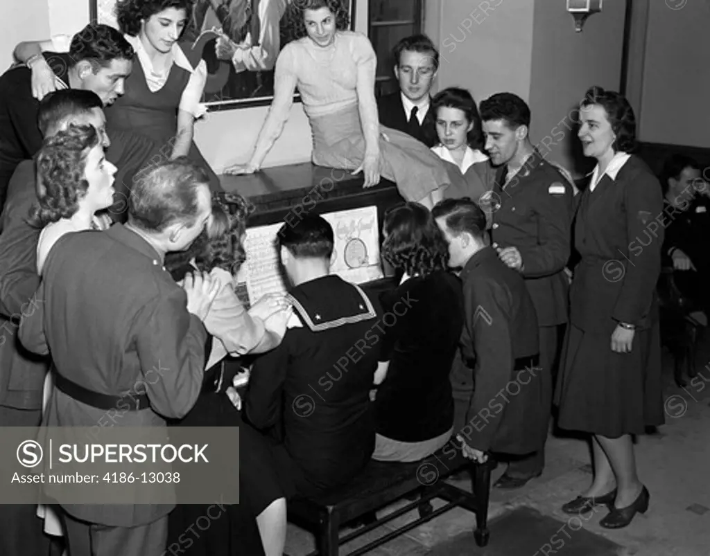 1940S Group Of Soldiers Sailors And Women In A Volunteer Uso Canteen Around Piano Singing